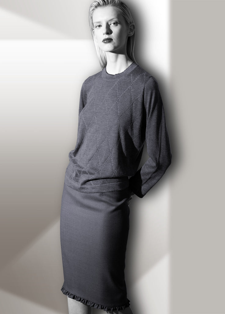 Opal grey skirt with ruffle border and cashmere argyle cable crew neck on model