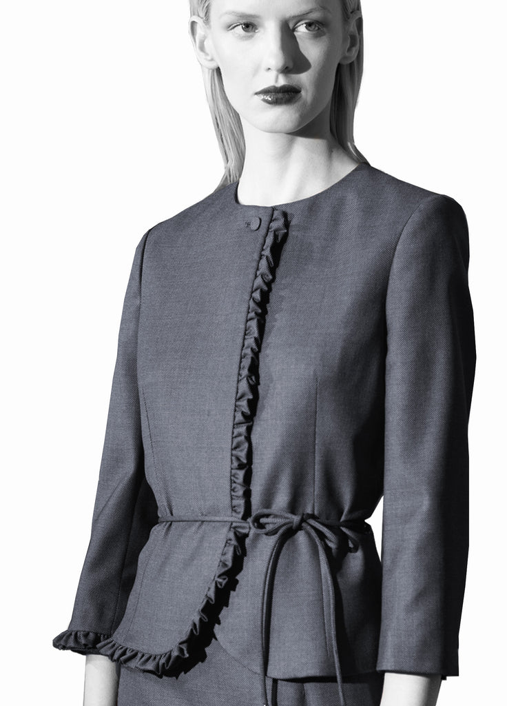 fine wool jacket with ruffle border detail on model in grey