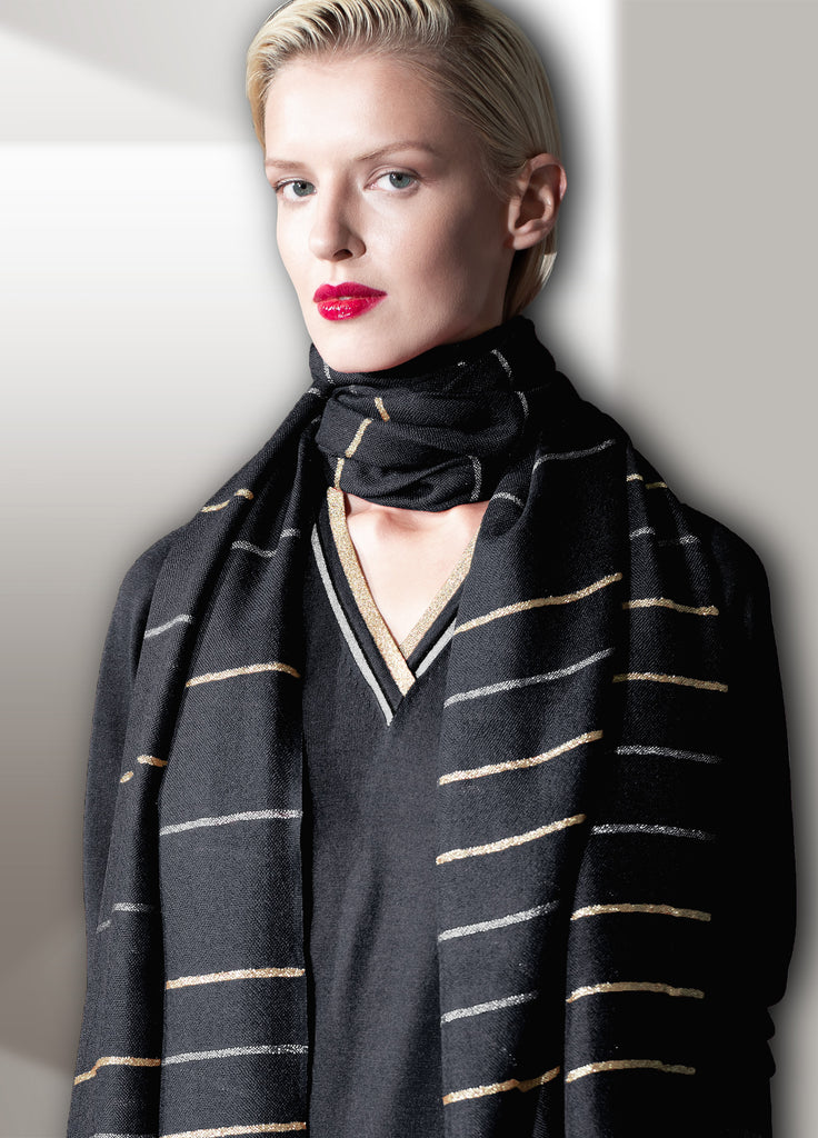 Model wearing ultra-fine cashmere scarf with silver and gold lame stripe and matching cashmere second skin V-neck with silver and gold metallic lame trim