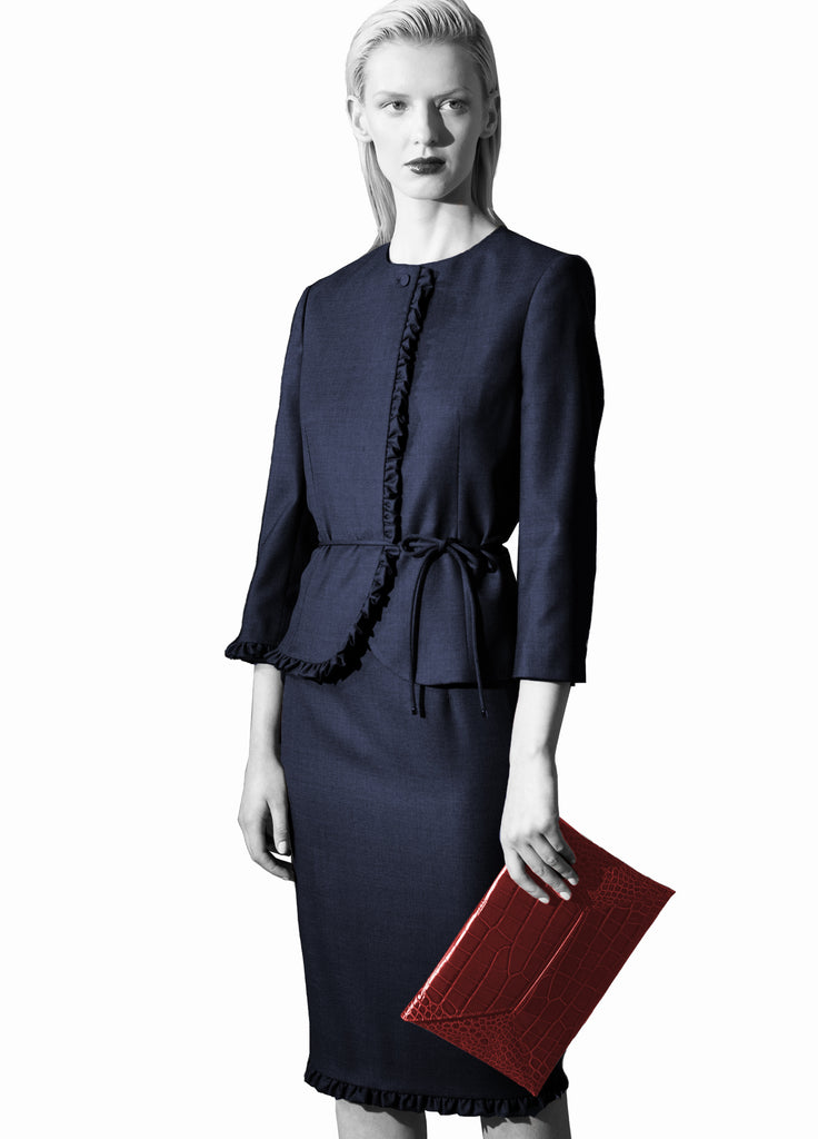 navy skirt suit with ruffles on model