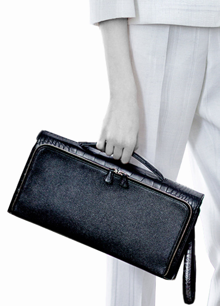 Model holding top handle clutch bag with multi compartment
